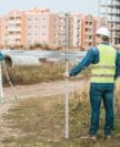 Surveyors Measuring Land With Digital Level And Ruler