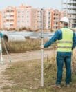Surveyors Measuring Land With Digital Level And Ruler